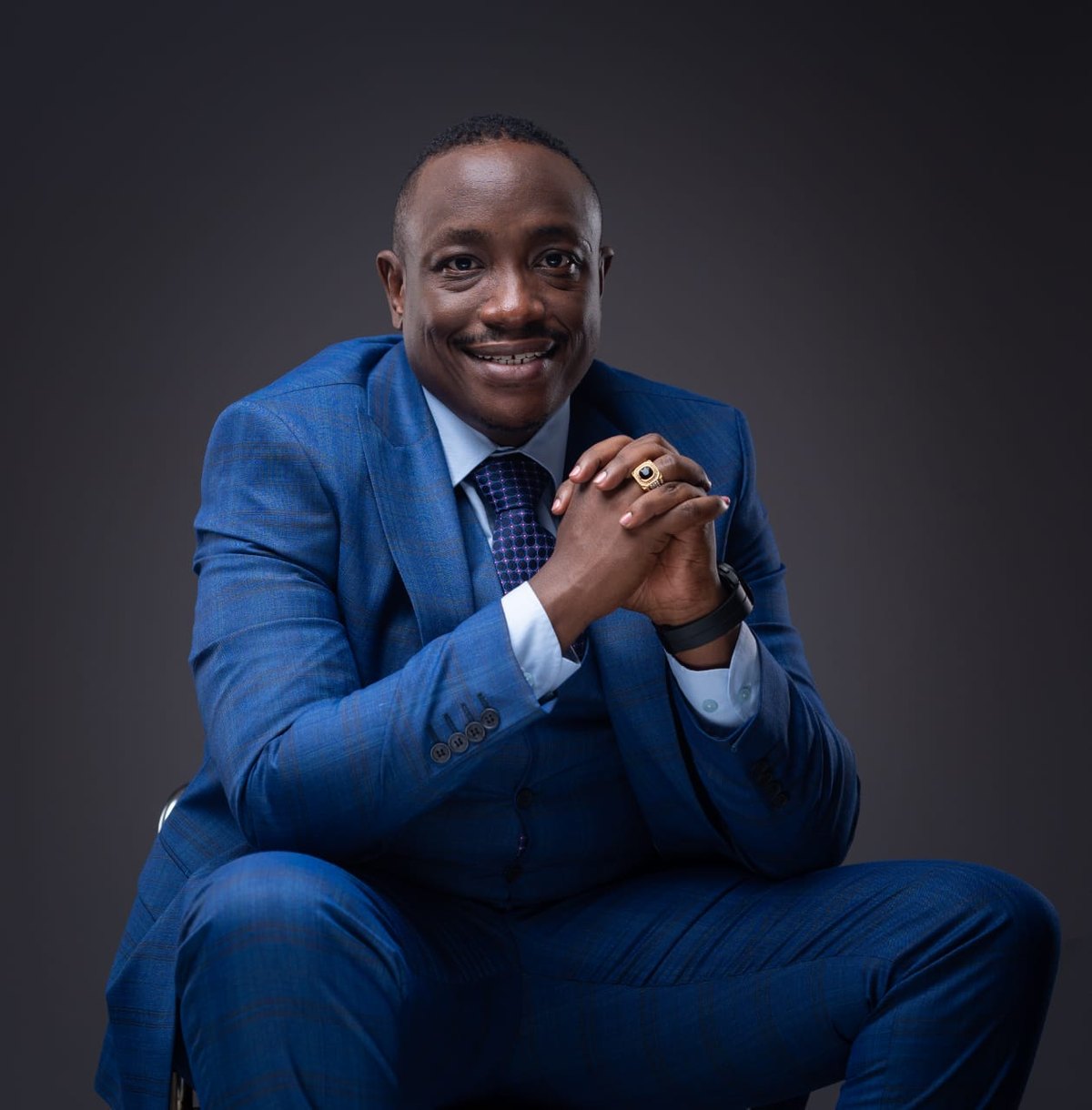 Pastor David Lai smiling in a blue suit
